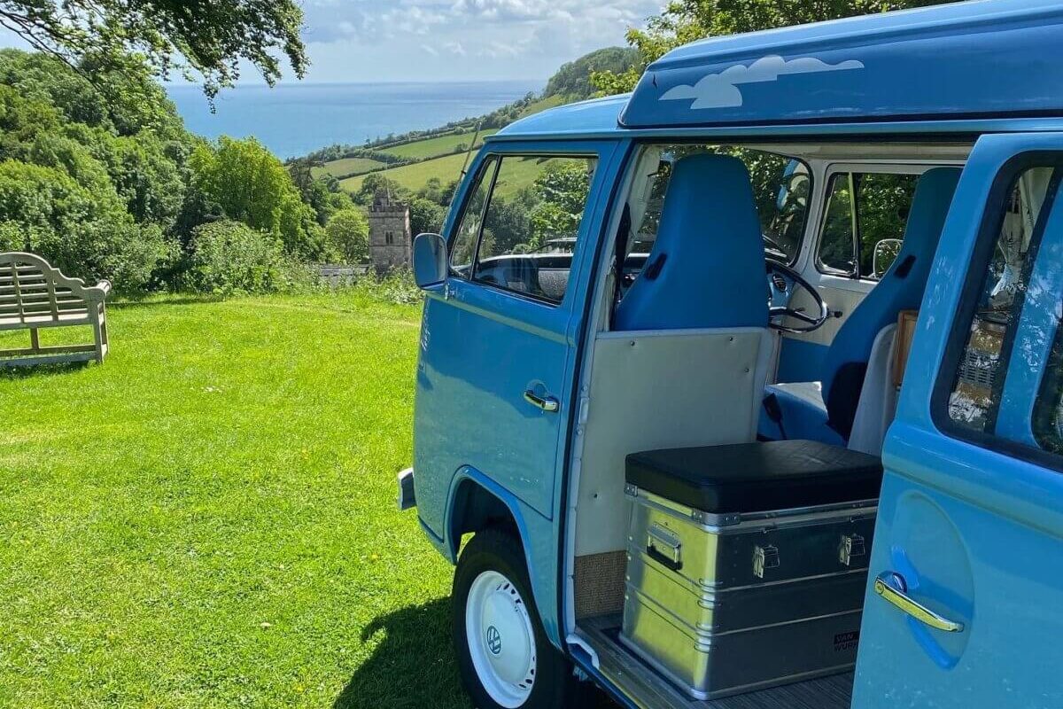 blue campervan with sea view